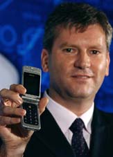 Tata Teleservices Chief Technology Officer Greg Young poses with a Nokia 6255 CDMA cellular telephone in Mumbai on Monday
