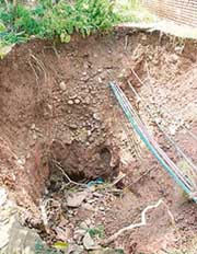 A 20-foot pit that has emerged after the land behind a row of houses caved in Sector 17, Panchkula.