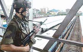 An Army jawan stands guard at the Guwahati railway station in Assam