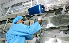 An inspector from the International Atomic Energy Organisation installs a surveillance camera in the Uranium Conversion Facility in Isfahan on Monday