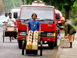Indonesian men transport oil in Jakarta on Tuesday