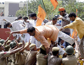 Police tries to control agitated activists of the BJP Yuva Morcha during a demonstration against 50 per cent reservation in Aligarh Muslim University in New Delhi on Tuesday. 