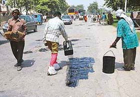 Men at work on the road dividing Sectors 31 and 32, Chandigarh