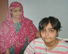 Hisar girl Ekta, who has secured 74.75 per cent marks in BA (I) despite her disability, with her mother.