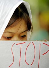 A member of the Manipur Students Association holds a placard during a peace rally in New Delhi on Wednesday.