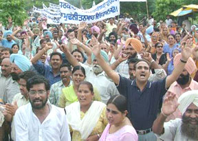 Teachers and employees of aided schools hold a rally outside the office of the Deputy Commissioner, Jalandhar, demanding withdrawal of the decision of the state government to stop release of grants, on Wednesday.