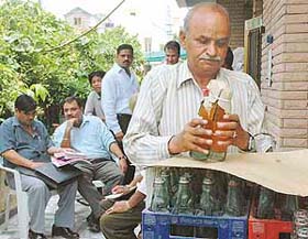 Health Department officials collect samples of soft drinks from an illegal bottling unit at Sector 10, Panchkula