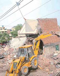 A portion of a dharamshala being demolished in Sector 26, Chandigarh