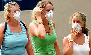 Tourists wear masks in downtown Kuala Lumpur on Thursday