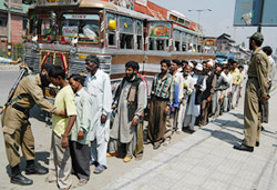 A Jammu and Kashmir policeman checks a passenger at a check-point in Srinagar on Friday. 