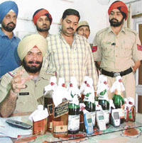 The police displays smuggled liquor seized from a shop in Gur Mandi in Ludhiana on Friday