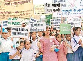 Students of a government middle school hold a rally to spread environment awareness in Jalandhar on Friday.