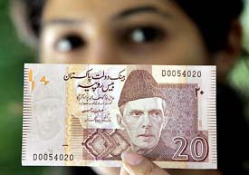 A Pakistani woman displays a new Rs 20 bank note in Islamabad on Saturday