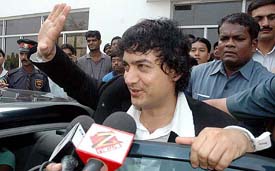 Bollywood star Aamir Khan acknowledges the cheers of his fans on his arrival at Netaji Subhash Chandra Airport in Kolkata on Saturday morning to promote his new film 
