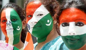 Students with Indian and Pakistani flags painted on their faces express greetings to both countries for the forthcoming Independence Day in Amritsar