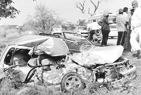 The mangled remains of the car after it collided head on with a bus on the Zirakpur-Patiala road near Rajpura