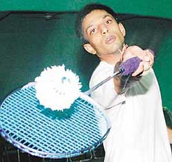 Piyush Aggrawal in action during a mens final match with Saurav at the Xth District Badminton Championship held at Tau Devi Lal Stadium in Panchkula on Sunday