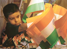 This boy dreams of a future as he looks at a bunch of national flags in Ludhiana on Sunday