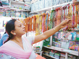 A woman selects a rakhi string for her brother as the festival celebrating the love of a brother and a sister is only a few days away