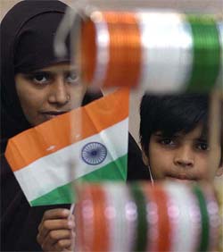 A woman and child look at tri-coloured bangles in old Delhi on the eve of the Independence Day