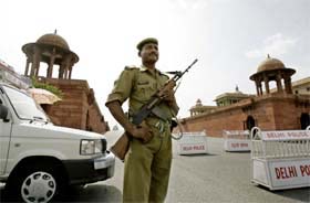 A policeman stands guard on Raisina Hill in New Delhi on the eve of Independence Day