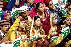 Pakistani children in traditional dresses hold national flags during a ceremony to celebrate the nations 58th independence day at the Jinnah Convention Centre in Islamabad on Sunday