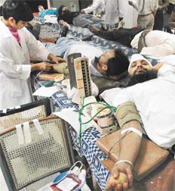 Volunteers donate blood at a blood donation camp organised by the Canara Bank Officers Association, at Sector 34, Chandigarh