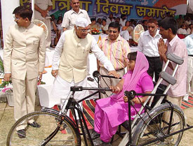 Haryana Chief Minister Bhupinder Singh Hooda distributes tricycles among handicapped on the occasion of the 59th Independence Day celebrations at Karnal on Monday