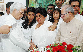 Defence Minister Pranab Mukherjee and External Affairs Minister K. Natwar Singh console Sugandi Kadirgamar (centre), wife of Sri Lanka's slain Foreign Minister Lakshman Kadirgamar in Colombo on Monday. 