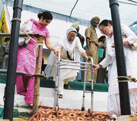 A physically challenged woman being helped on the dais of Independence Day function in Ludhiana on Monday