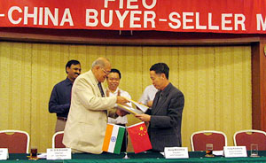 Dr R.K. Dhawan, Chairman, Federation of Indian Export Organisations, Northern Region, and Mr Wang Wen Xiangex, Chairman, Guangzhou Sub-Council of China Council for the Promotion of International Trade, exchange the memorandum of understanding on Tuesday in Guangzhou city