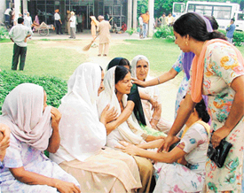 Mother of Harinder Kaur, who was found dead in her in-laws house, being consoled by her friends and relatives outside the Civil Hospital, Ludhiana