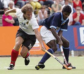 Indias Ignace Tirkey and Germanys Nicolas Emmerlingh fight for the ball during their Rabo Trophy hockey match in Amstelveen on Tuesday