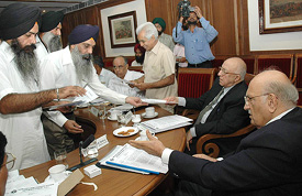 Members of the Punjab Rights Forum present complaints about the false implication of Sikh youths by the police in cases of sedition and the Explosive Act before members of the National Commission for Minorities in Chandigarh on Wednesday.