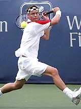 Australias Lleyton Hewitt hits a backhand shot during his match against Russias Igor Andreev in the first round of the Cincinnati Masters in Mason