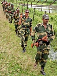 Soldiers patrol near the India-Bangladesh border on the outskirts of Siliguri on Thursday. Patrolling has been intensified in the border areas as hundreds of crude bombs exploded simultaneously in towns and cities throughout Bangladesh on Wednesday. 