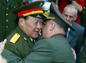 Gen Liang Guanlie, chief of the general staff of the Chinese People's Liberation Army, and Gen Yuri Baluyevsky, head of the Russian armed forces general staff, hug before a meeting on their joint military exercise in Vladivostok, Russia