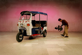 A cameraman films a Thai tuk tuk covered with over 100,000 crystals inside a studio in the outskirts of Bangkok on Friday. Tuk tuks, which are named after the sound of their engines, are generally used as taxis in Thailand. The crystal tuk tuk is equipped with a audio-video sound system and is priced at more than two million baht (around $50,000).