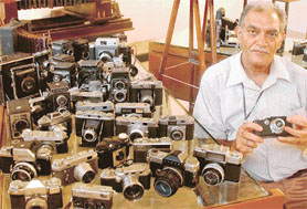 Suresh Kumar relaxes in the company of his cameras which he displayed in Government Museum on the occasion of World Photography Day today. 
