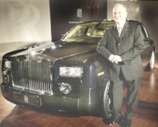 Regional Director of Asia-Pacific Rolls-Royce Motor Cars Colin Kelly poses with the newly-launched Rolls-Royce Phantom car in New Delhi on Saturday. The car is priced between Rs 3.5 crore to Rs 4 crore. Ultra-luxury carmaker Rolls-Royce plans to sell 10 to 12 units of Phantom in the Indian market this year and is also planning to launch a new convertible model codenamed RR02 in 2007.