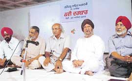Santokh Singh Dheer (Second from right) recites a poem at a kavi darbar at Sector 41, Chandigarh, on Saturday.