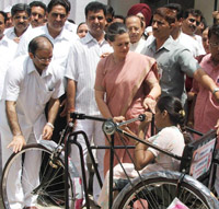 DPCC president Rambabu Sharma with Congress president Sonia Gandhi presenting a tricycle to a girl in the Capital on Saturday.