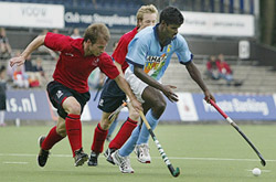 Two England players battle for the ball with Indias Ignace Tirkey (right) during the 7th-8th place playoff match at the Rabobank hockey tournament in Amstelveen on Saturday. 