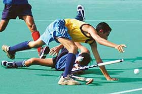 Forward player of Dorahas Friends Academy being checked by fullback of DAV Academy during the Fourth S.N. Vohra Memorial Sub-Junior (u-14) Hockey Tournament at the Sector 42 hockey stadium in Chandigarh
