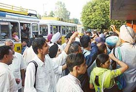 Heavy rush at Phase VI bus stop, Mohali, as Punjab Roadways buses are not entering Chandigarh