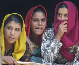 Kashmiri women supporters listen to a speech of Peoples Conference Chairman Sajjad Ghani Lone at his first public rally at Auzgoo Budgam, 60 km from Srinagar