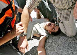 A Jewish settler screams in pain after a scuffle with Israeli soldiers near the settlement of Sanur, West Bank, on Sunday. Israeli forces marched into three Jewish settlements in the Gaza Strip, hoping to complete the evacuation of the biggest bloc of enclaves in the occupied territory.