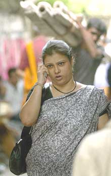 A woman converses on her cellphone in Kolkata on Monday. India, with some 59 million cellphone users, the second-largest user country in Asia, has completed 10 years of mobile telephone use.