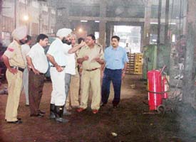 Joint Commissioner Jaswant Singh and other MC and fire brigade staff inspect fire safety measures at R K Machine Tools in Ludhiana on Monday. 