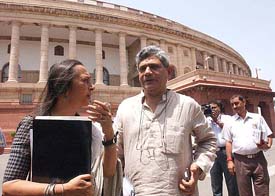 CPM Politburo members Brinda Karat and Sitaram Yechuri come out of Parliament after taking oath as Rajya Sabha members in New Delhi on Monday